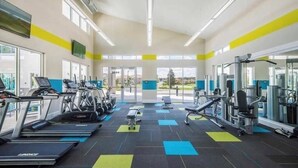 A gym with treadmills, weight machines, and a bench. - Amazing 5 bedroom house near Disney (Kissimmee)