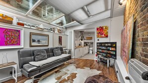 A modern living room with a leather sofa, a cowhide rug, and a large TV. -  5star central zone1 -2 bed 2 bath Slps 6 superWifi  (London)