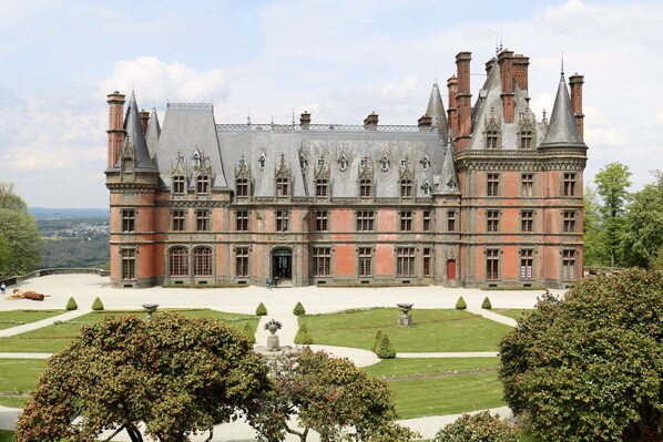 A large, historic building with multiple towers and a symmetrical facade.