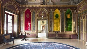 An ornate hall with a large circular carpet, arched windows, and detailed ceiling artwork. - At Kalsa Quiet & Flowered Terrace Free Parking! Ideal for remote working! (Palermo)