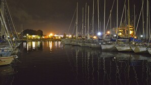 A marina at night with boats docked and illuminated by ambient lighting. - At Kalsa Quiet & Flowered Terrace Free Parking! Ideal for remote working! (Palermo)