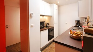A compact kitchen with white cabinets, a microwave, a kettle, and a toaster. - Studio La Savoyarde 4 stars Vision Luxe for 2 people Annecy (Menthon-Saint-Bernard)
