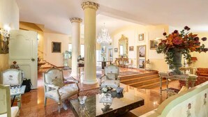 A grand lobby with marble flooring, classical columns, and elegant furniture. - Luxury SPA Villa with Private Pool, Jacuzzi,Pine Forest - Available for Weddings (Partinico)