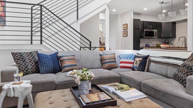 A modern living room with a grey sofa, a coffee table, and a staircase. - Outpost: Clark's Knoll 385 - Walk to Town Square (Jackson)