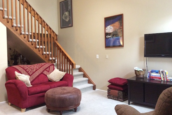 Living room + stairway to bedroom/work area upstairs