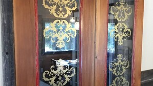 A set of wooden sliding doors with ornate gold designs and red trim. - Rustic luxury deep in the heart of Texas  (Hamilton)