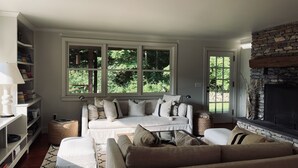 A cozy living room with a sofa set, a fireplace, and a bookshelf. -  Catskills Sanctuary  (Delancey)