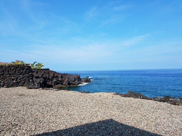 A rocky shoreline with a clear view of the ocean.