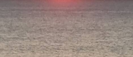 A sunset over a calm sea.
