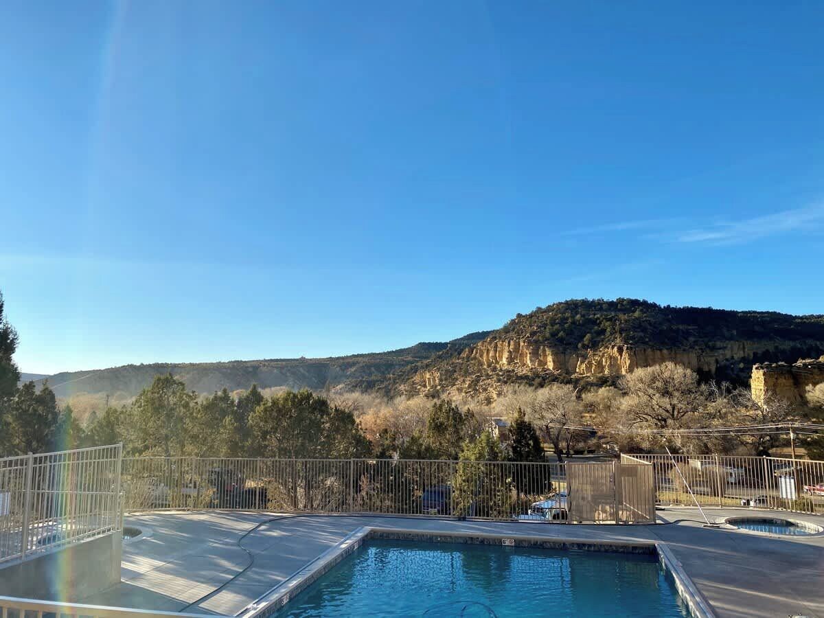 A swimming pool with a view of a mountainous landscape.