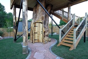 A wooden structure with a staircase and a door. - Unique Treehouse near Zion with King Bed (Orderville)