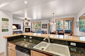 Enjoy cooking in this well-lit kitchen with a large island, double sink, and dishwasher.