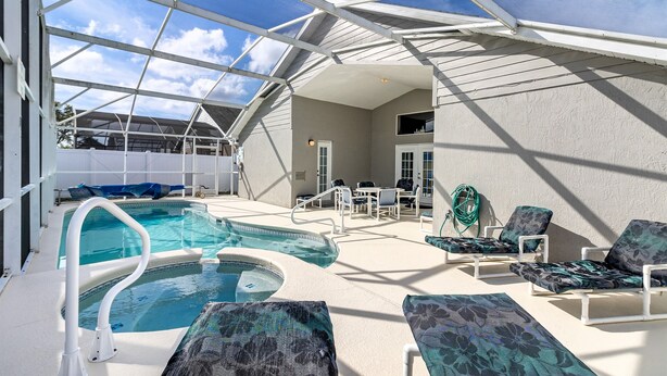 A rooftop pool area with lounge chairs, a hot tub, and a covered seating area. - Fairytale Villa - 2 Masters, Privacy Fence! (Kissimmee)