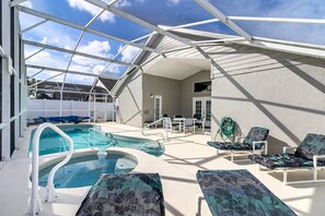 A rooftop pool area with lounge chairs, a hot tub, and a covered seating area. - Fairytale Villa - 2 Masters, Privacy Fence! (Kissimmee)