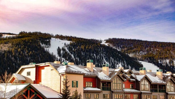 A row of traditional wooden buildings with a ski slope in the background. - 4BR4BA Keystone Condo Rental, Walk to Lifts.. GreatRentalKeystone in The Gateway (Keystone)