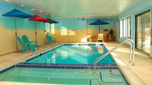 An indoor swimming pool with blue tiles, a metal ladder, and two blue umbrellas. - 4BR4BA Keystone Condo Rental, Walk to Lifts.. GreatRentalKeystone in The Gateway (Keystone)