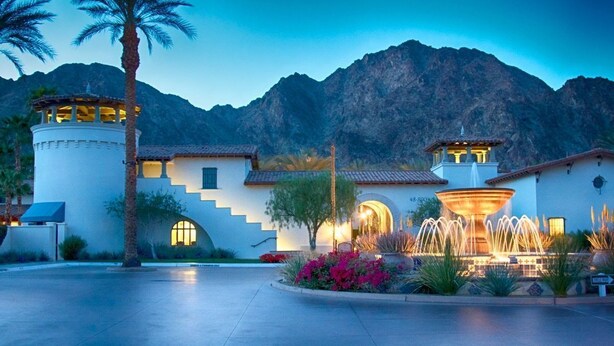 A hotel with a fountain, palm trees, and a mountainous backdrop. - Legacy Villas private villa w/ view- steps to pool- bikes & arcade game included (La Quinta)