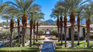 A resort with palm trees, a swimming pool, and a mountain in the background. - Legacy Villas private villa w/ view- steps to pool- bikes & arcade game included (La Quinta)