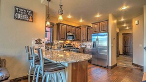 A kitchen with granite countertops, stainless steel appliances, and wooden cabinets. - Minutes from World Class Ski Resorts, Hot Tub! (Silverthorne)