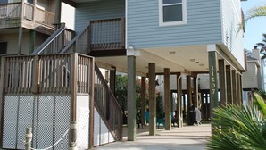 A two-story building with a covered walkway and a balcony. - Sunny Beach Luxurious House with View, Sleeps 12, Steps From Beach (Galveston)