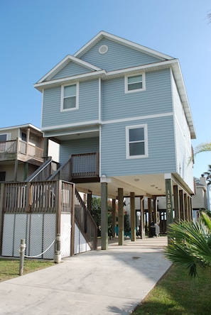 A two-story building with a covered walkway and a balcony.