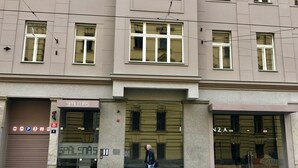 A building with a storefront labeled "SPÁLENAS" and a large glass window. - Art Suites Spalena (Prague)