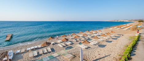 På stranden, solstolar, parasoller och strandhanddukar