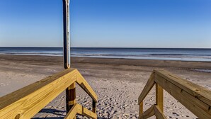 A wooden beach boardwalk leading to the ocean with a clear sky. - Charming Studio Apartment E - Steps to Beach & Dining (Saint Simons Island)