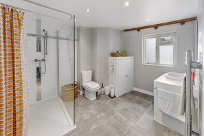 Shower, rainfall showerhead, hair dryer, towels