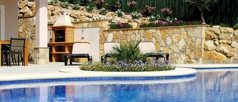 A heated pool, pool loungers