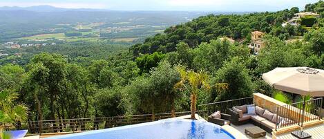 Een verwarmd zwembad, ligstoelen bij het zwembad