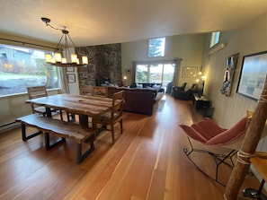 Relax in this inviting living area with a dining table, comfortable sofa, and a cozy chair.
