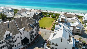 A coastal hotel with multiple buildings, a beach, and a clear view of the ocean.