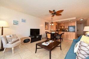 Living area blending cozy seating, entertainment, and dining flow with tropical charm. - BeachFront Condo w Sunset Ocean Views - Kahana Reef 103 (Lahaina)