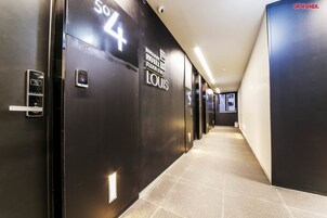 A hallway with black doors numbered 50 to 54, indicating hotel rooms.
