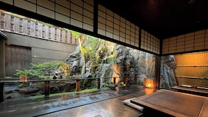 A traditional Japanese room with tatami flooring, a rock garden, and a view of a bamboo forest through a shoji screen. - Yuzuya Ryokan - Adult Only (Kyoto)