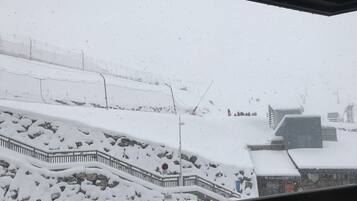 A snowy outdoor scene with a staircase and a fence.