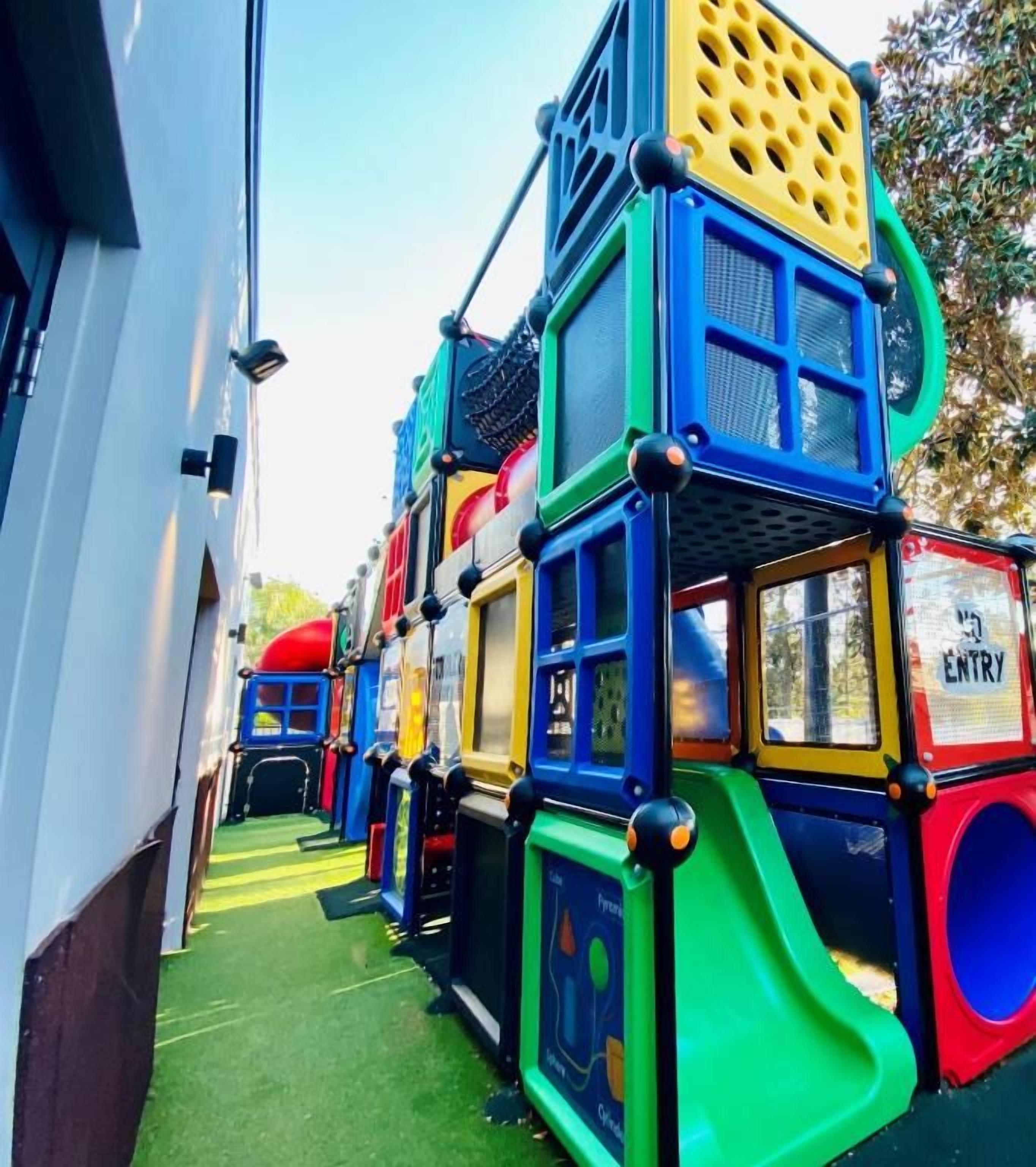 A multi-level play structure with various slides and climbing elements.