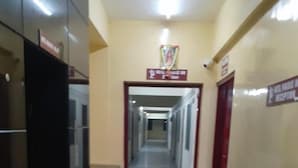 A hallway with a marble floor leading to a reception area.