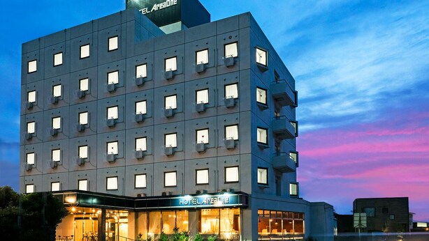 A multi-story hotel with a modern design, featuring a prominent sign at the entrance and multiple balconies. - Hotel AreaOne Tokai (Tokai-mura)