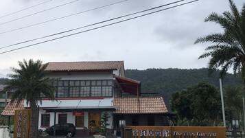 A building with a tiled roof and a sign that reads "The Tiles Garden."