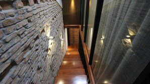 A narrow staircase with wooden steps and a brick wall on one side. - Lorong Jambatan Melaka (Malacca City)
