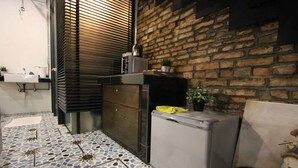 A compact kitchen with a refrigerator, a sink, and a tiled floor. - Lorong Jambatan Melaka (Malacca City)