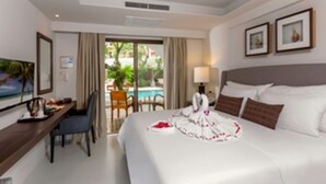A hotel room with a bed, a desk, a chair, a TV, and a view of the outside. - New Patong Premier Resort (Patong)