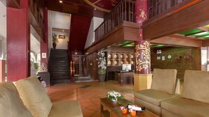 A spacious lobby with a staircase, a reception desk, and a seating area with sofas and a coffee table. - New Patong Premier Resort (Patong)