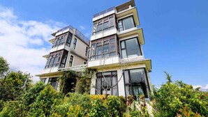 A multi-story building with a modern architectural design, featuring large windows and a flat roof. - My Sweetie B&B (Dongshan)