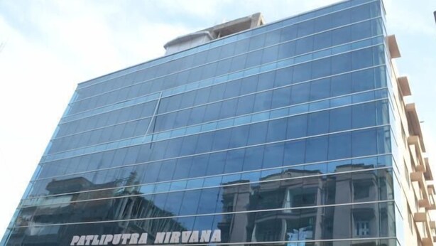 A modern glass building with the name "PATIPUTRA NIRVANA" visible on its facade. - Hotel Patliputra Nirvanaa (Patna)