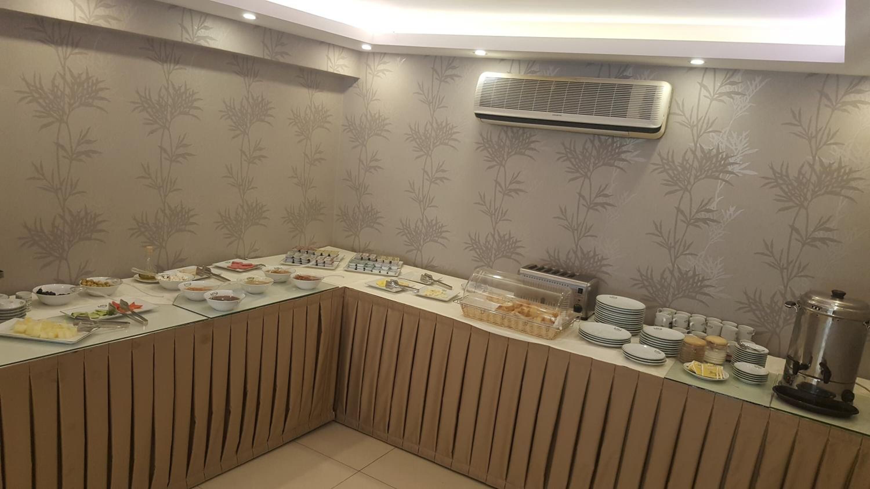 A buffet setup with various food items and a coffee machine.