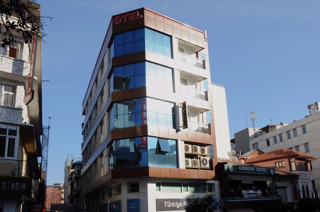 A multi-story hotel with a modern facade, featuring large windows and balconies.