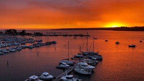 A marina with boats docked at the pier during sunset. - Le Nautica by Akena Hotels (Perros-Guirec)